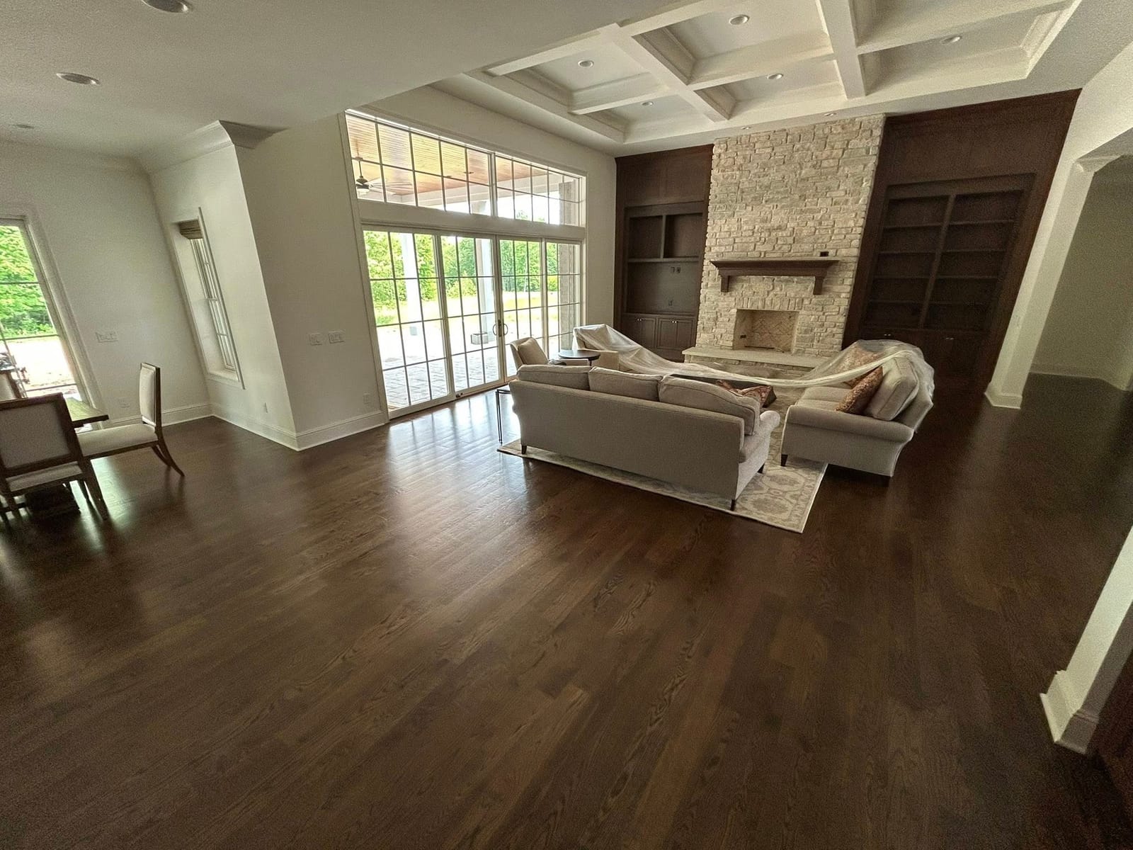 Living room with coffered ceiling and hardwood